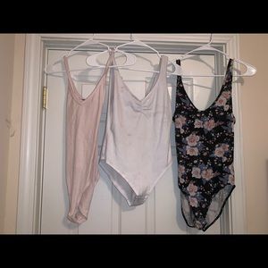 Three bodysuits